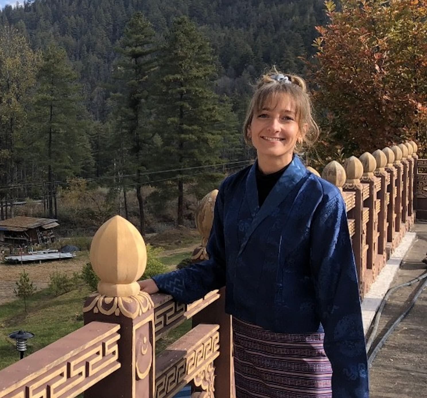 A young woman standing on a bridge in Bhutan